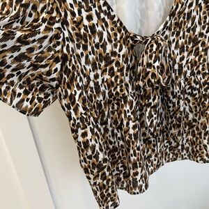 Banana Republic leopard print dressy top with short sleeves and bow at back.